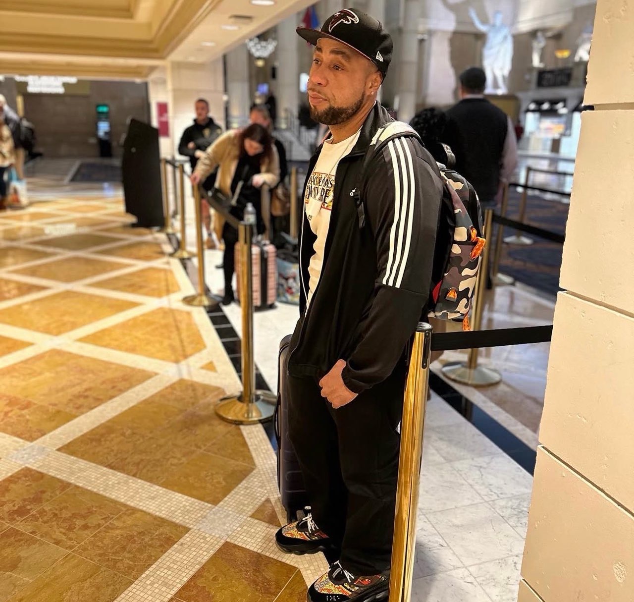 Tmac standing in a hotel lobby